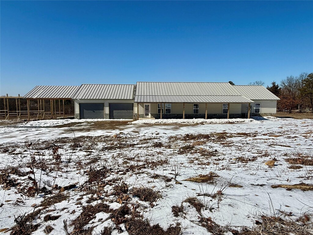 view of front of home featuring a garage and metal roof