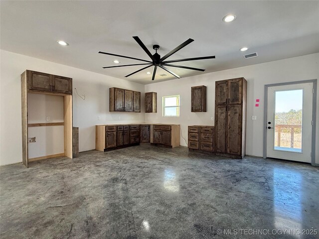 unfurnished living room with concrete flooring and ceiling fan