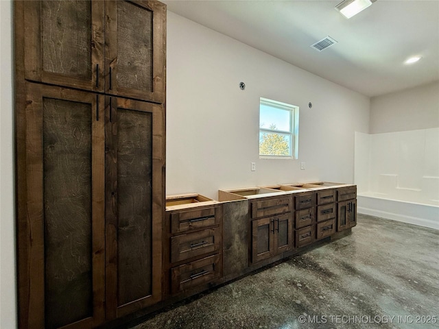 bathroom featuring a bath and concrete floors