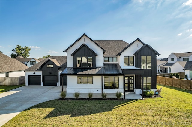 modern farmhouse featuring a garage and a front yard