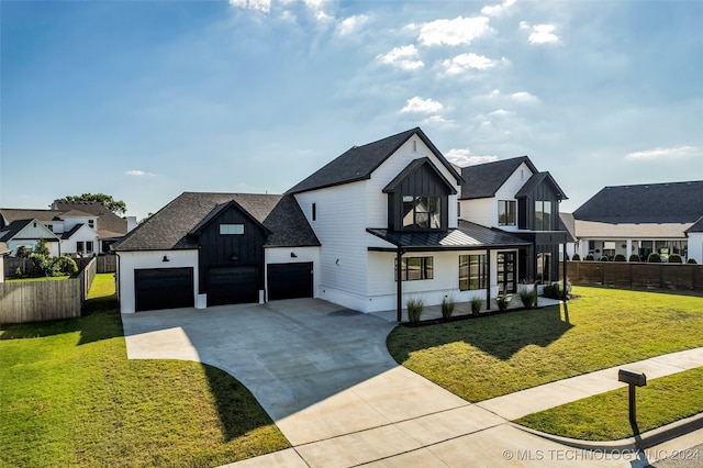 modern farmhouse featuring a garage and a front yard