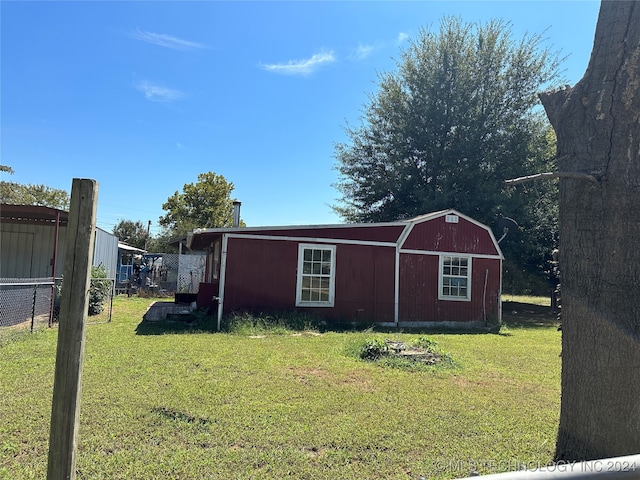 view of outbuilding featuring a lawn