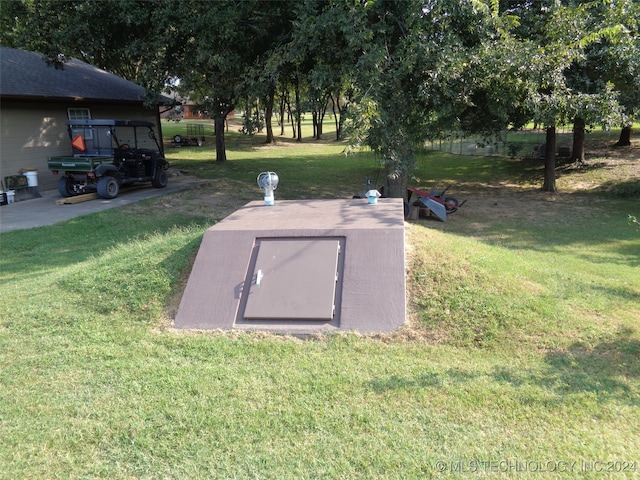 view of storm shelter featuring a lawn