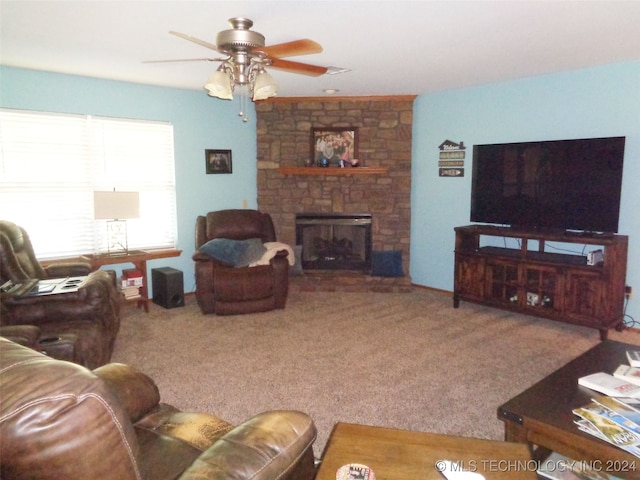 carpeted living room featuring ceiling fan and a fireplace