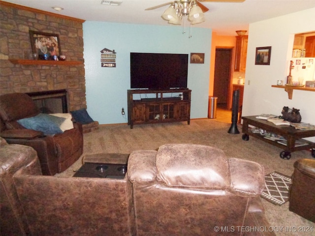 carpeted living room featuring ceiling fan and a fireplace