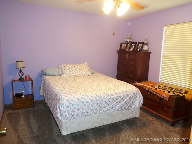 bedroom featuring dark carpet and ceiling fan