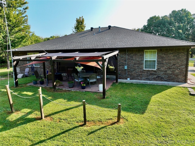 rear view of house with a patio area, a lawn, and a gazebo