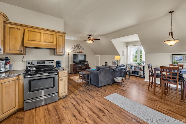 kitchen with hanging light fixtures, hardwood / wood-style flooring, vaulted ceiling, electric range, and ceiling fan