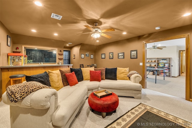 living room featuring ceiling fan and carpet