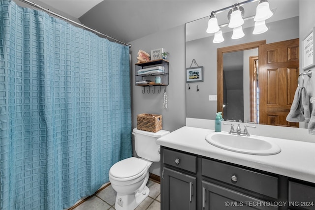 bathroom with a shower with curtain, tile patterned flooring, toilet, and vanity