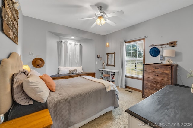 bedroom with ceiling fan and light carpet