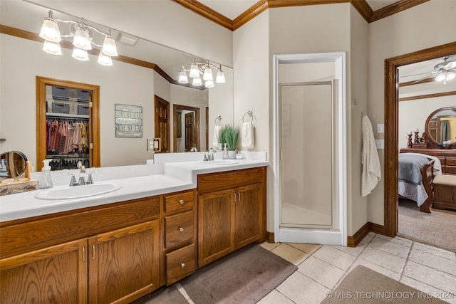 bathroom with crown molding, vanity, walk in shower, and tile patterned flooring