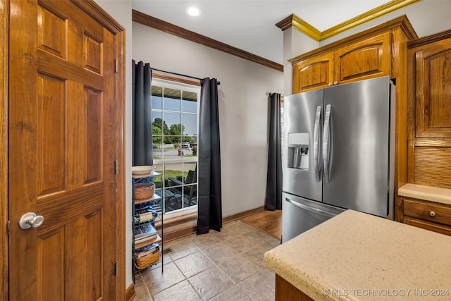 kitchen with crown molding and stainless steel fridge