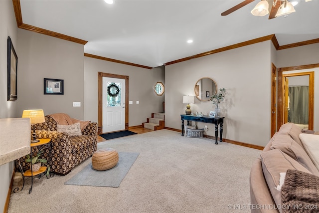 carpeted entryway with crown molding and ceiling fan