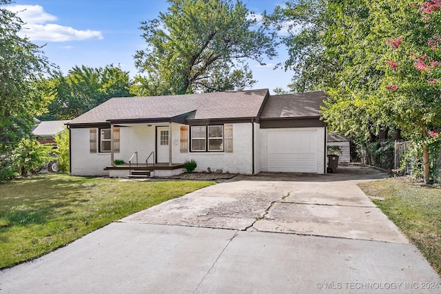 ranch-style home with a front yard and a garage