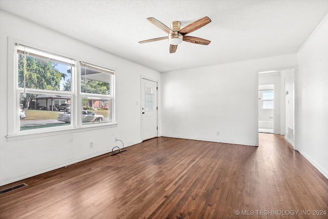 empty room with a textured ceiling, ceiling fan, and hardwood / wood-style flooring