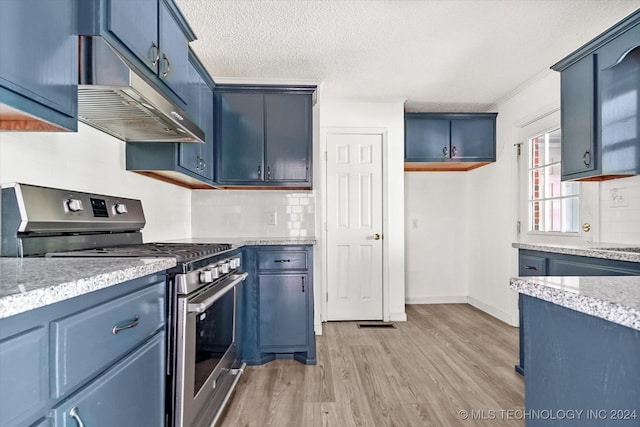 kitchen featuring stainless steel gas range, a textured ceiling, backsplash, blue cabinets, and light hardwood / wood-style floors