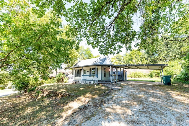 view of front of house featuring covered porch and a carport