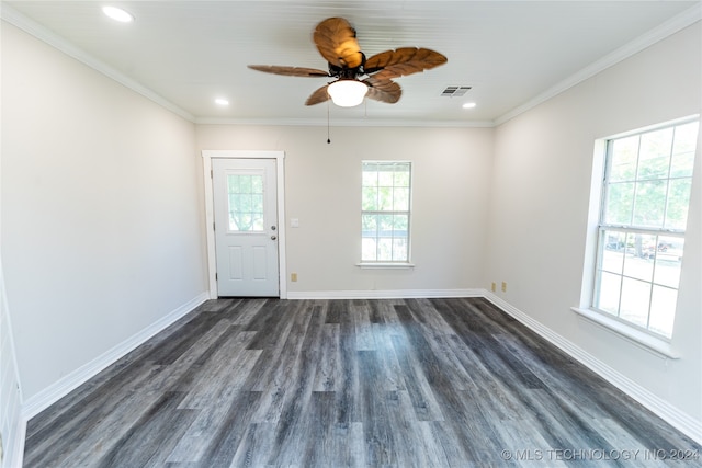 spare room featuring dark wood-type flooring, ceiling fan, and ornamental molding