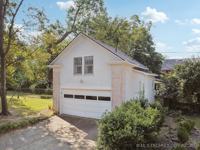 view of side of home featuring a yard and a garage