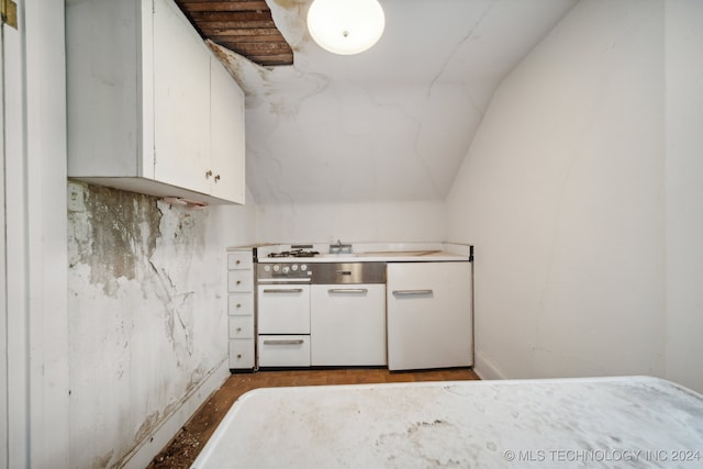 kitchen with white cabinets and lofted ceiling