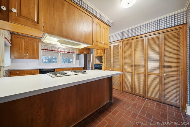 kitchen with exhaust hood and appliances with stainless steel finishes