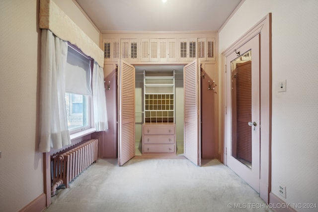 interior space with radiator and a closet