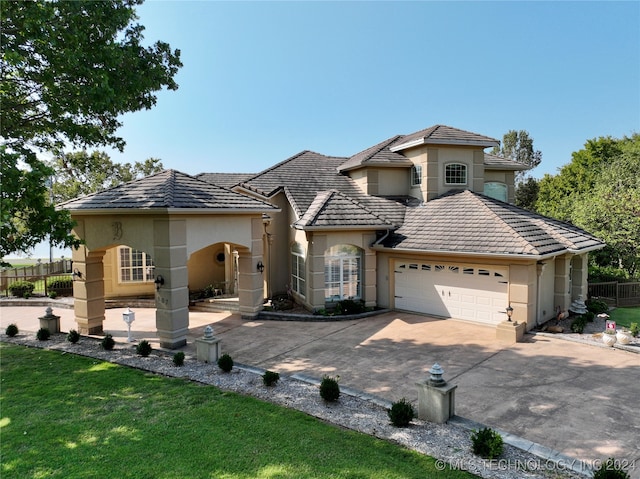 view of front of house featuring a garage and a front lawn