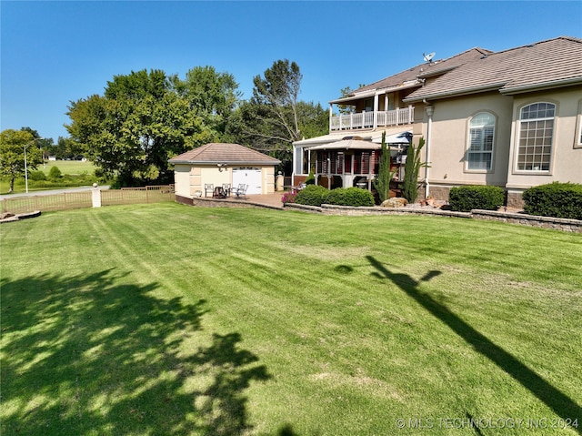 view of yard featuring a balcony and a patio