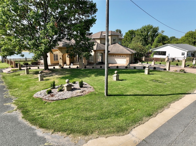 view of front of house featuring a front yard and a garage