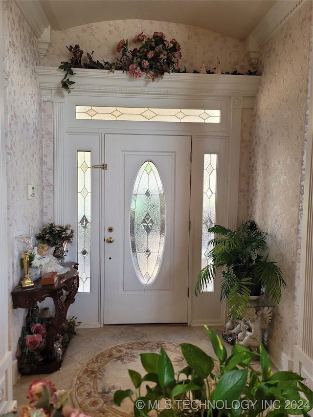 tiled foyer entrance with vaulted ceiling