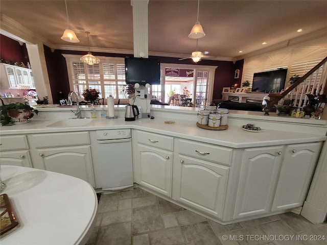 kitchen with white cabinets, crown molding, ceiling fan with notable chandelier, sink, and pendant lighting