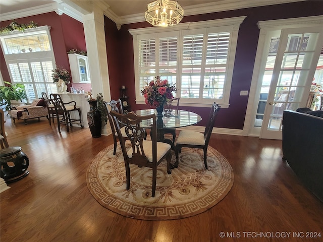 dining room featuring an inviting chandelier, dark hardwood / wood-style flooring, and ornamental molding