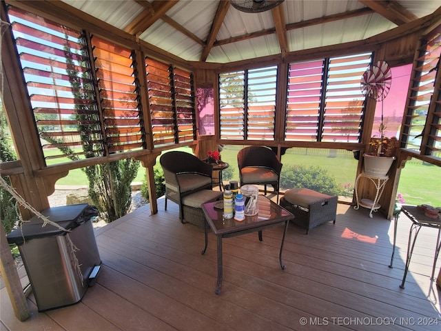 sunroom featuring lofted ceiling with beams