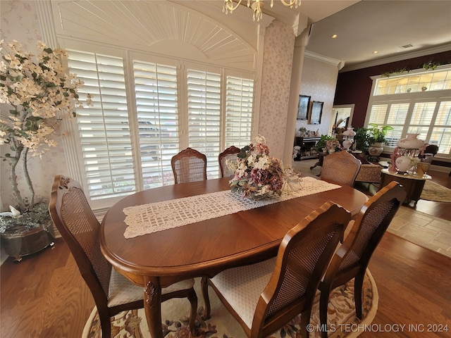 dining space featuring ornamental molding, plenty of natural light, and hardwood / wood-style floors