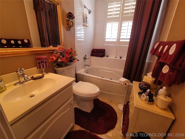 bathroom with vanity, toilet, a bathtub, and tile patterned floors