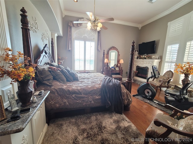 bedroom featuring ornamental molding, ceiling fan, and dark hardwood / wood-style floors