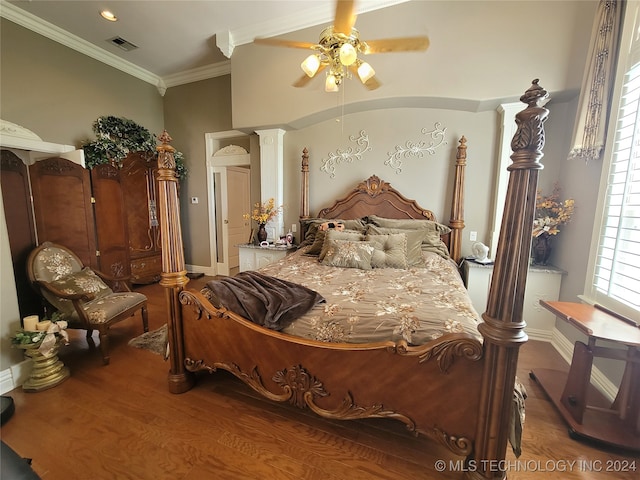 bedroom featuring ceiling fan, ornamental molding, wood-type flooring, and decorative columns