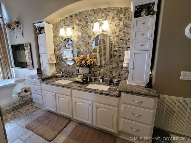 bathroom with vanity and tasteful backsplash