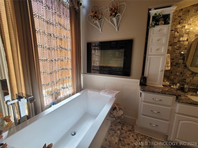 bathroom featuring vanity, tasteful backsplash, and tile patterned floors