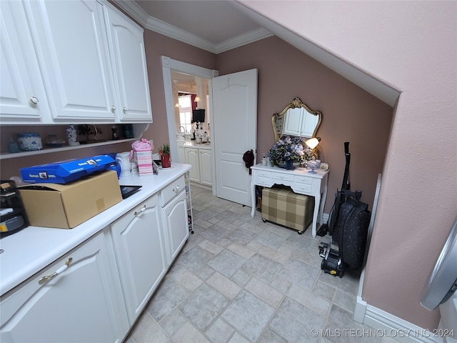 kitchen with white cabinetry and ornamental molding