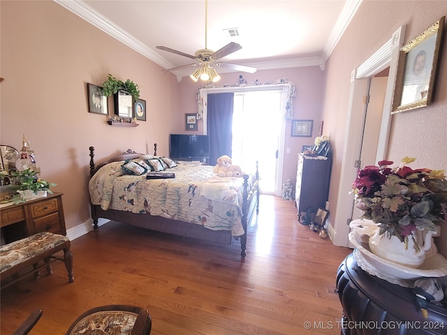 bedroom with multiple windows, ceiling fan, hardwood / wood-style flooring, and crown molding