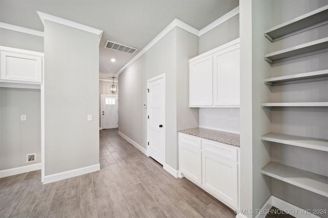 interior space featuring light wood-type flooring and crown molding