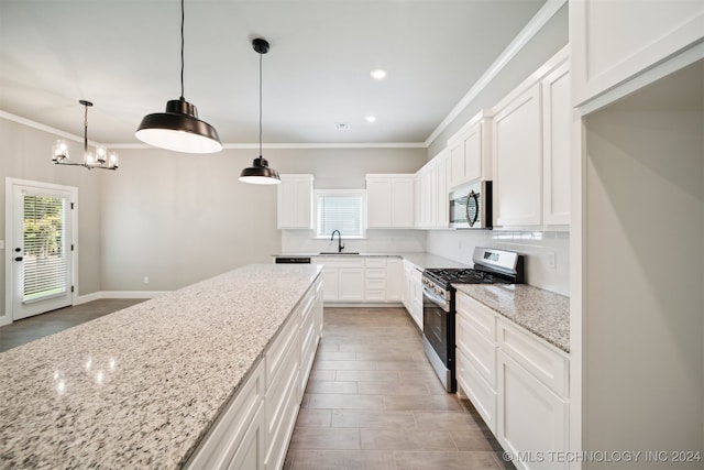 kitchen featuring plenty of natural light, stainless steel appliances, sink, and white cabinets