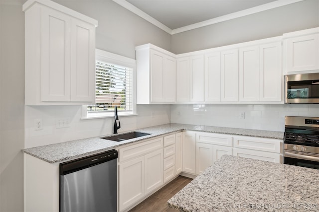 kitchen featuring white cabinetry, stainless steel appliances, sink, light stone countertops, and dark hardwood / wood-style floors