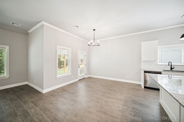 kitchen with white cabinets, hardwood / wood-style flooring, decorative light fixtures, sink, and stainless steel dishwasher