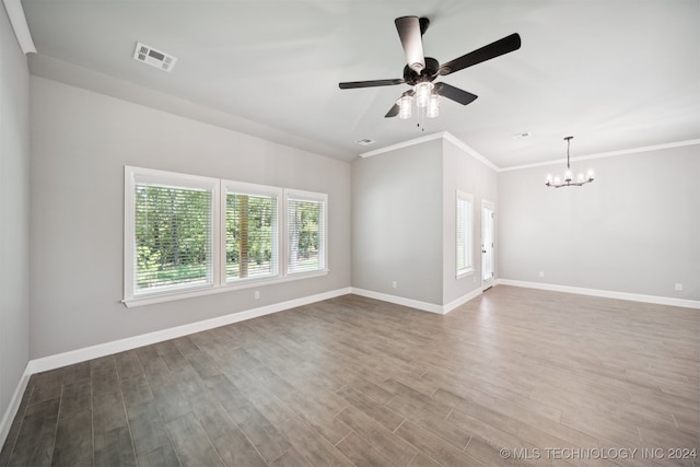 empty room with ceiling fan with notable chandelier, ornamental molding, and hardwood / wood-style flooring