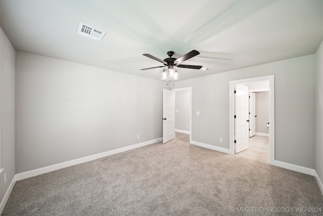 unfurnished bedroom featuring light colored carpet and ceiling fan