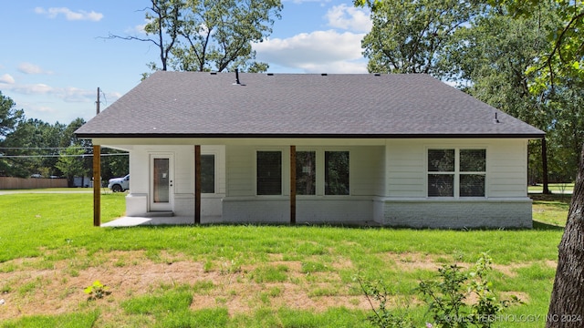 back of house with a lawn