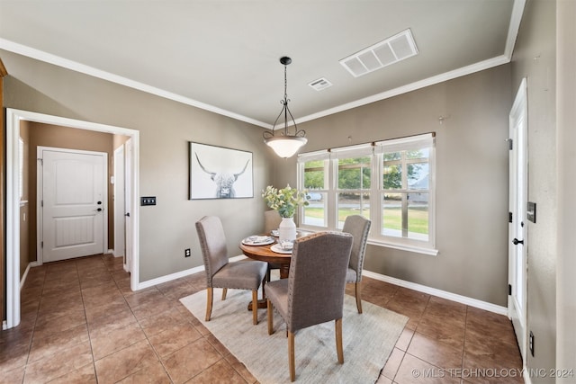 dining area with tile patterned flooring and crown molding